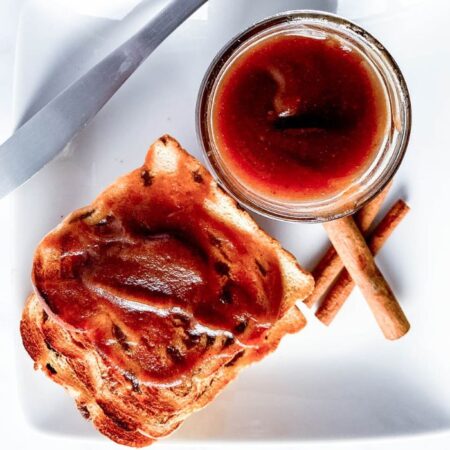 toast on plate with jar of apple butter on plate