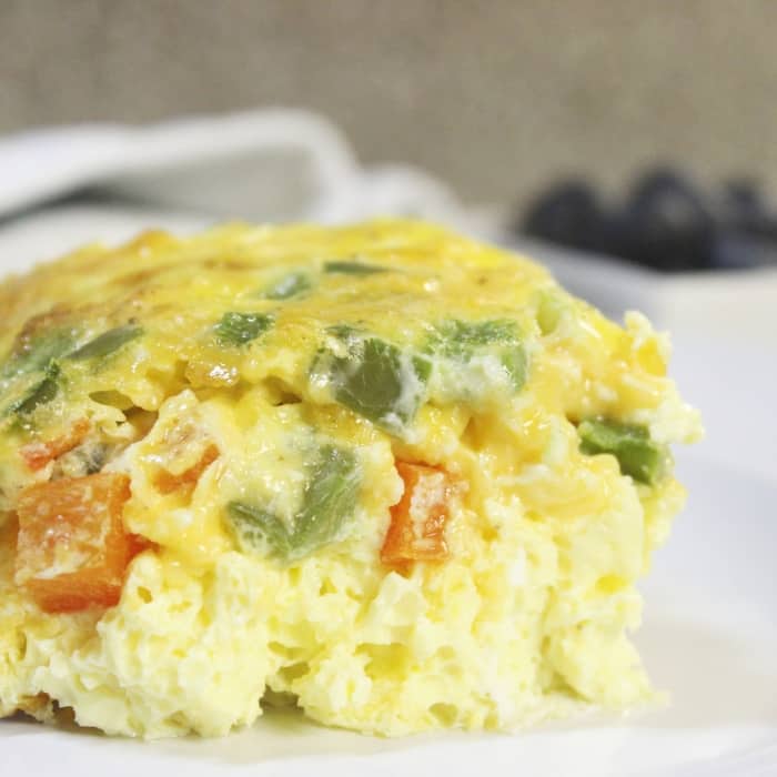 Serve up this baked western omelette for breakfast, lunch, or dinner! Easy prep, and within no time you have a fluffy egg omelet baked in the oven. #western #denver #omelette #easy #baked #casserole #peppers #cheese #breakfastcasserole #recipe #ham #bake #simple #Athome #lunch #healthy baked western omelette on a plate