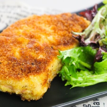 breaded pork chop on plate with salad