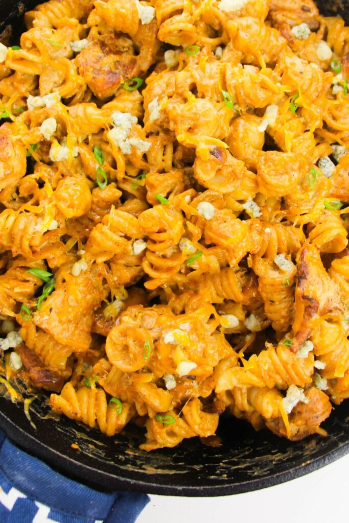 buffalo pasta chicken bake in a cast iron skillet