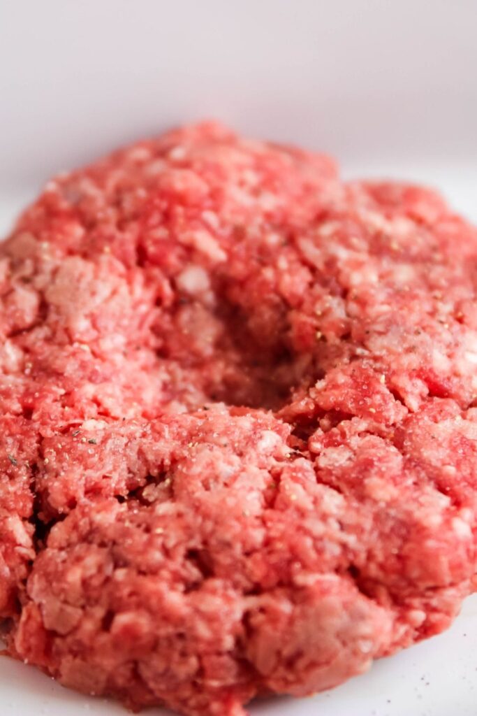 close up of burger with center pushed down