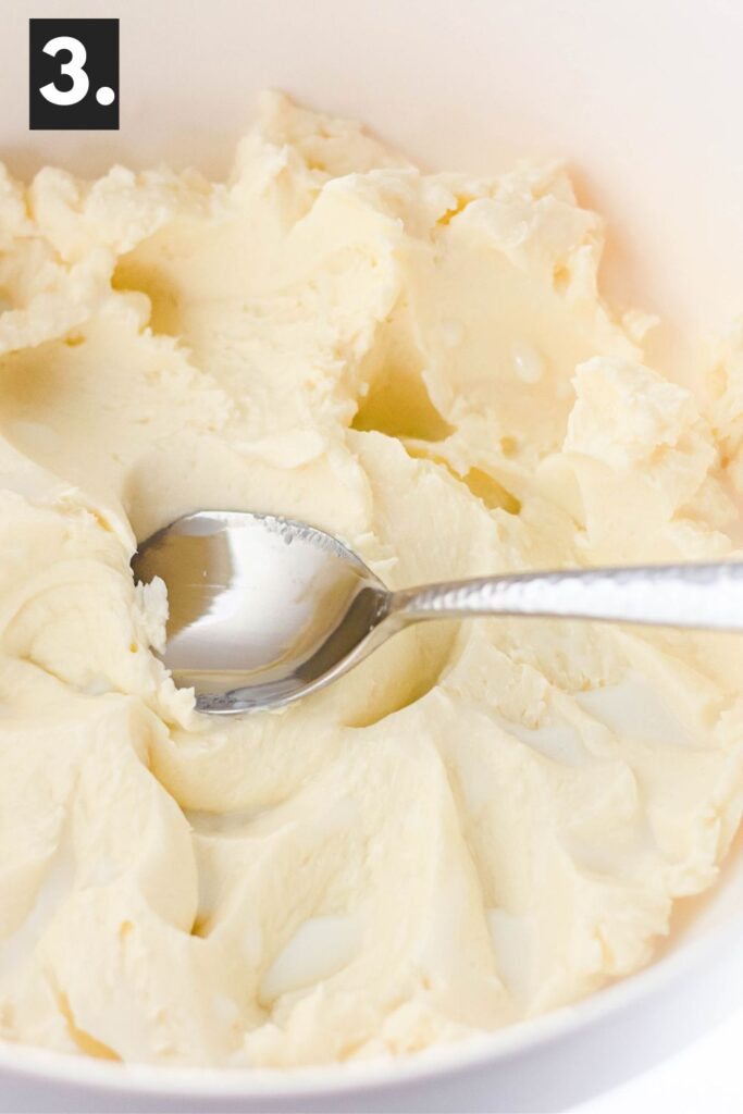 butter in a bowl with a spoon that has spread it around smooth