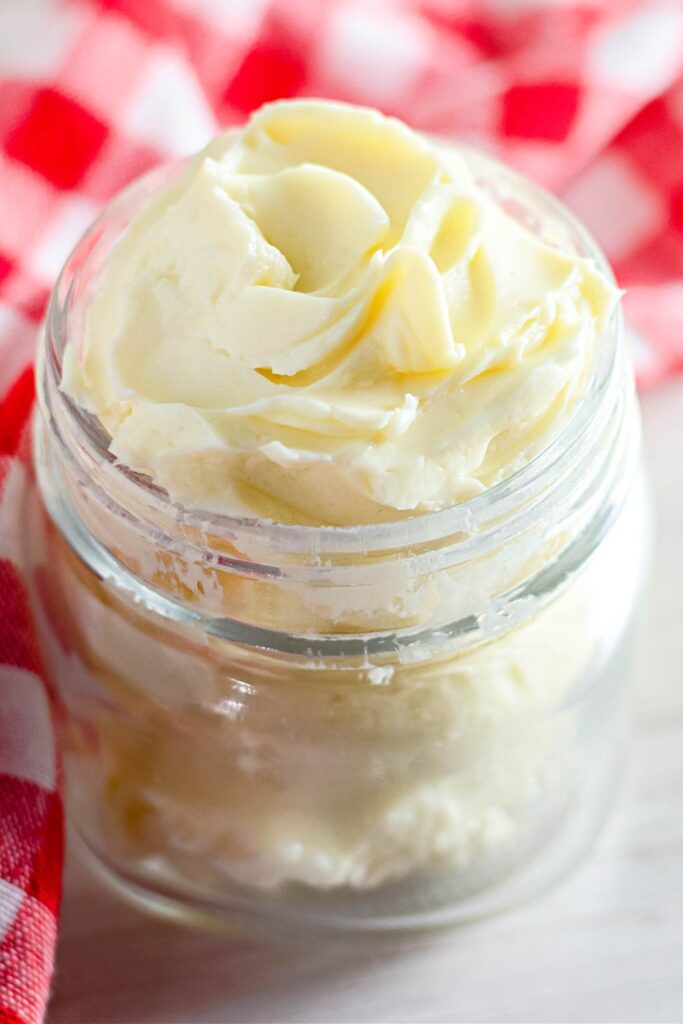 homemade butter piped into a mason jar on table