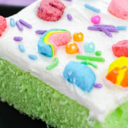 cereal cake on plate with Lucky Charms on top