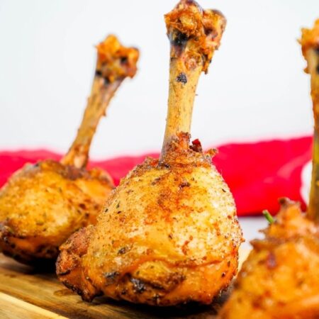 chicken drumstick lollipops on cutting board