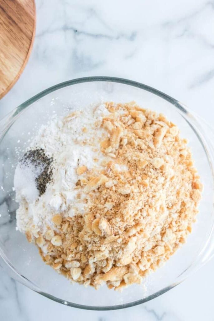 crushed crackers, spices and flour in a small bowl on table
