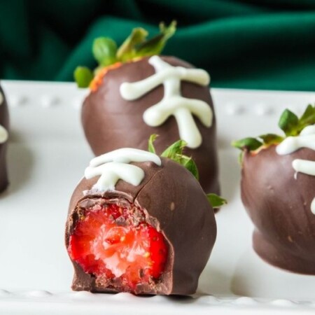 platter with chocolate strawberries with bite taken it out
