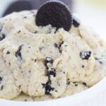 bowl of Oreo cookie dough in a white bowl with Oreo cookie on top