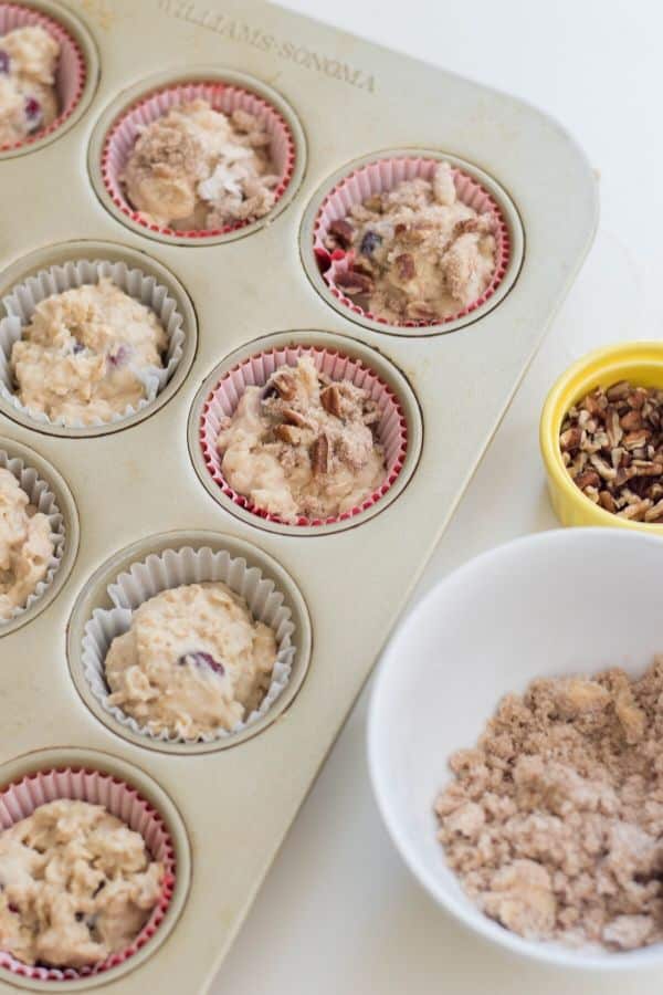 Cranberry muffins are a delicious winter muffin recipe. Cranberry muffins with a walnut streusel topping. Bake up and freeze for breakfast on the go. #cranberry #frozen #freezerfriendly #muffins #holiday #christmas #recipe #dessert #streusel #walnut #oatmeal #best #easy cranberry baked good