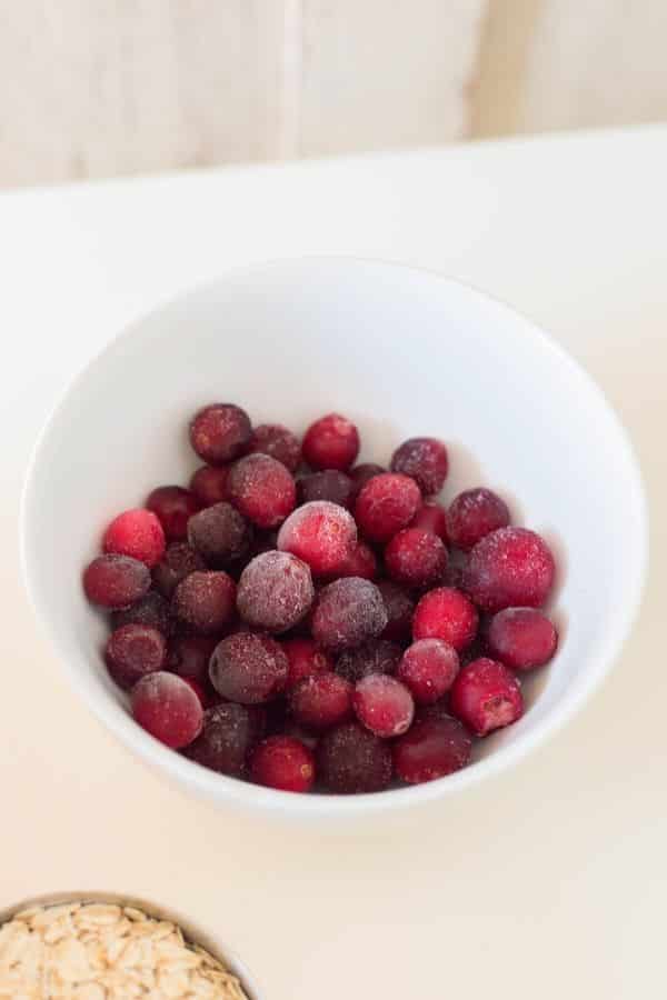 Cranberry muffins are a delicious winter muffin recipe. Cranberry muffins with a walnut streusel topping. Bake up and freeze for breakfast on the go. #cranberry #frozen #freezerfriendly #muffins #holiday #christmas #recipe #dessert #streusel #walnut #oatmeal #best #easy cranberry baked goods