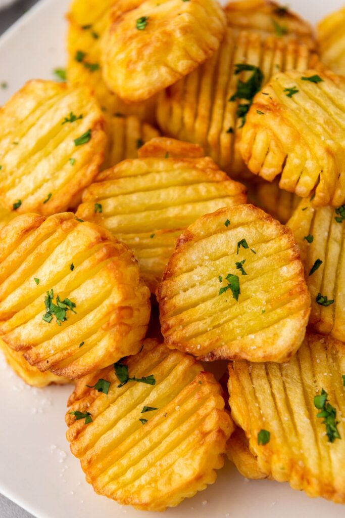 plate of potatoes with garnish on top