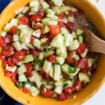 cucumber salsa in a yellow bowl on table