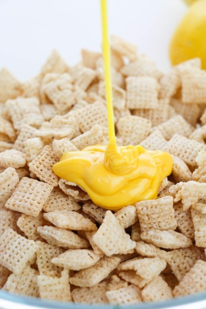chocolate being poured on chex cereal