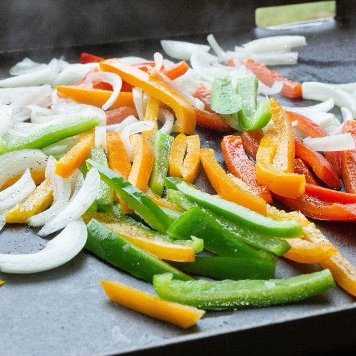 peppers and onions cooking on Blackstone Griddle