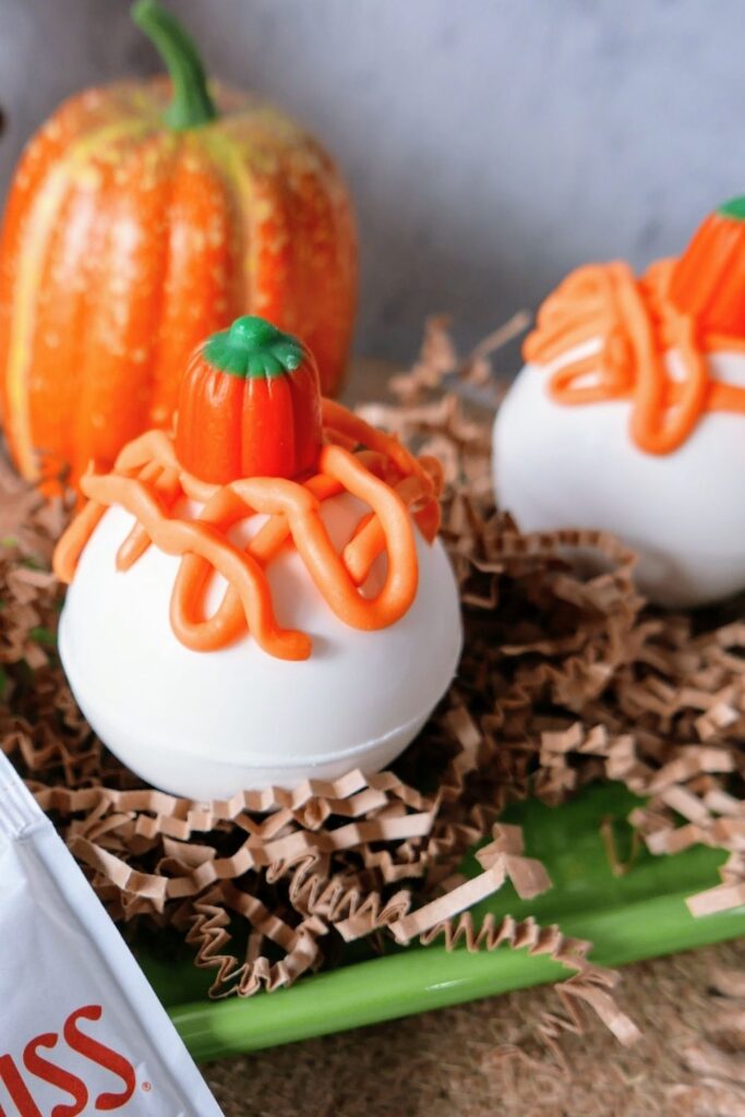 side view of hot chocolate bomb with orange icing on top