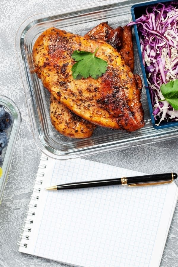 food in container with pen and paper by it