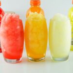 gatorade slushies on a table with bottles behind it