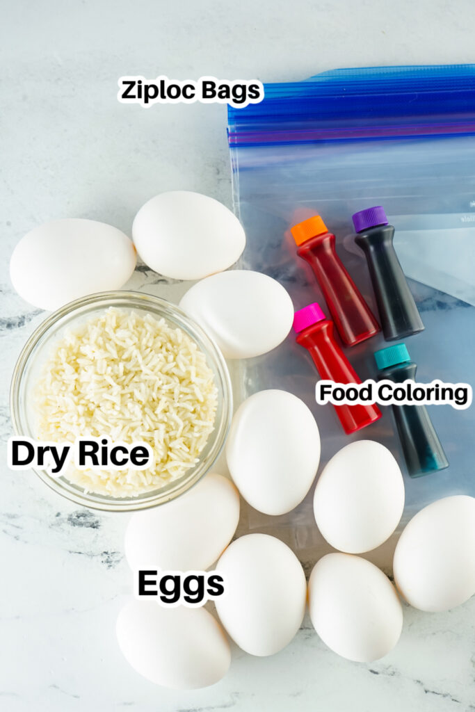 marble counter with eggs, rice, and food coloring on table