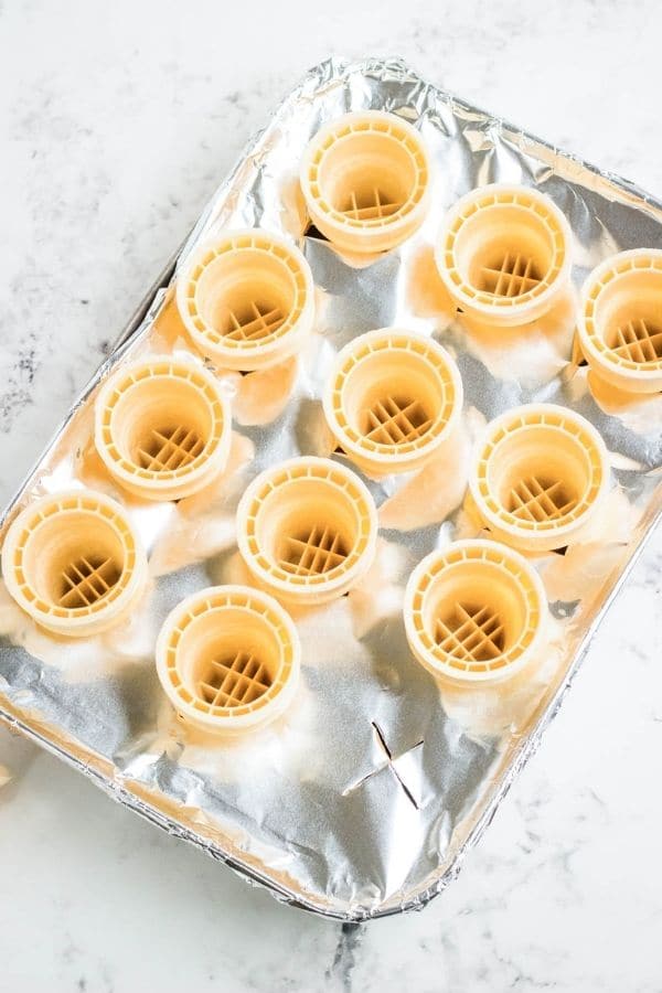 ice cream cones in a pan with aluminum foil