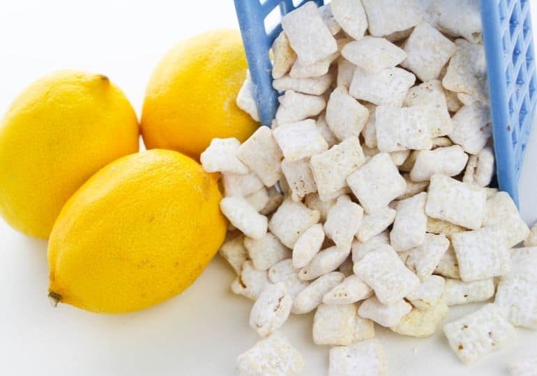 puppy chow coming out of a bowl with lemons beside it