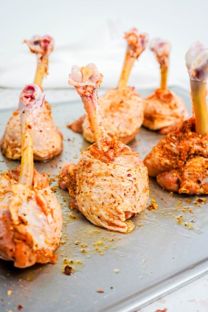 lollipop chicken on baking sheet