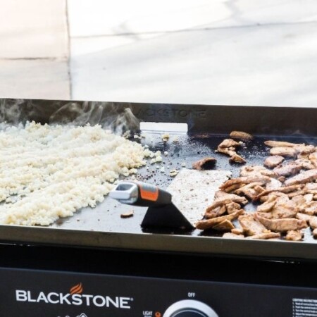 chicken and cauliflower rice cooking on blackstone grill