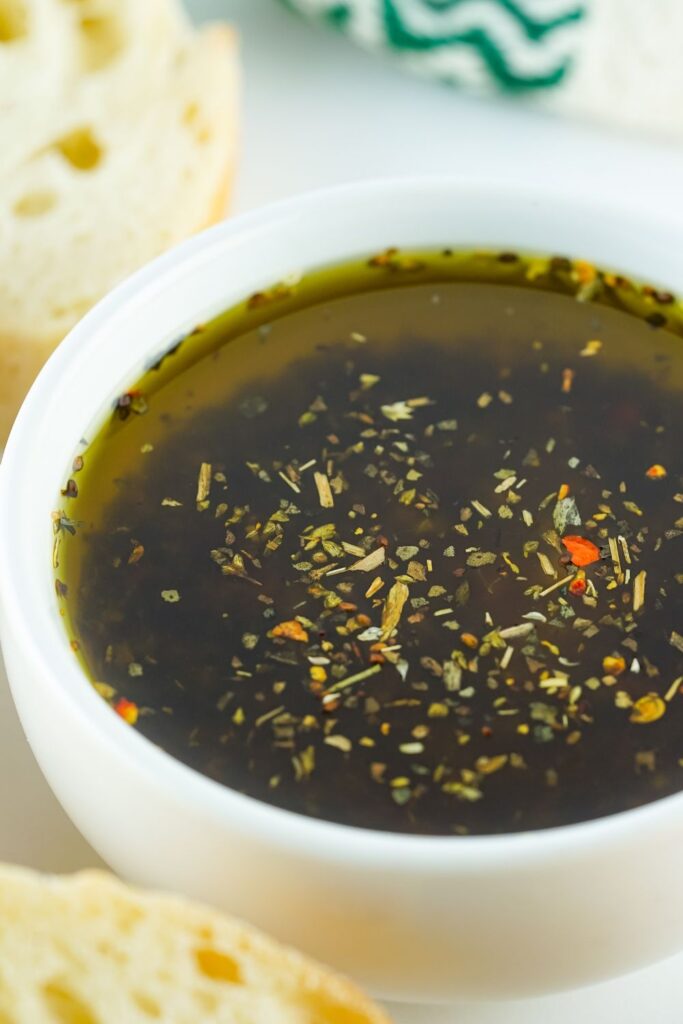 olive oil dipping sauce in a white bowl