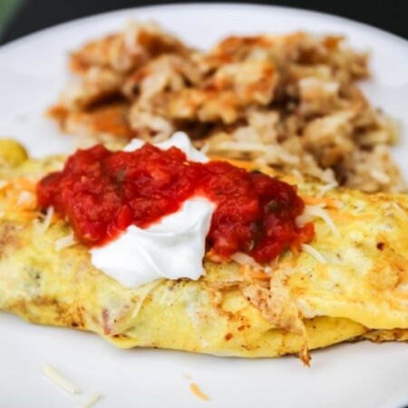 omelette and hashbrowns on white plate