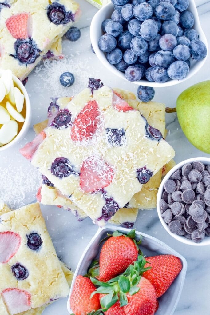 pancakes on table with fresh fruit and stuff around it