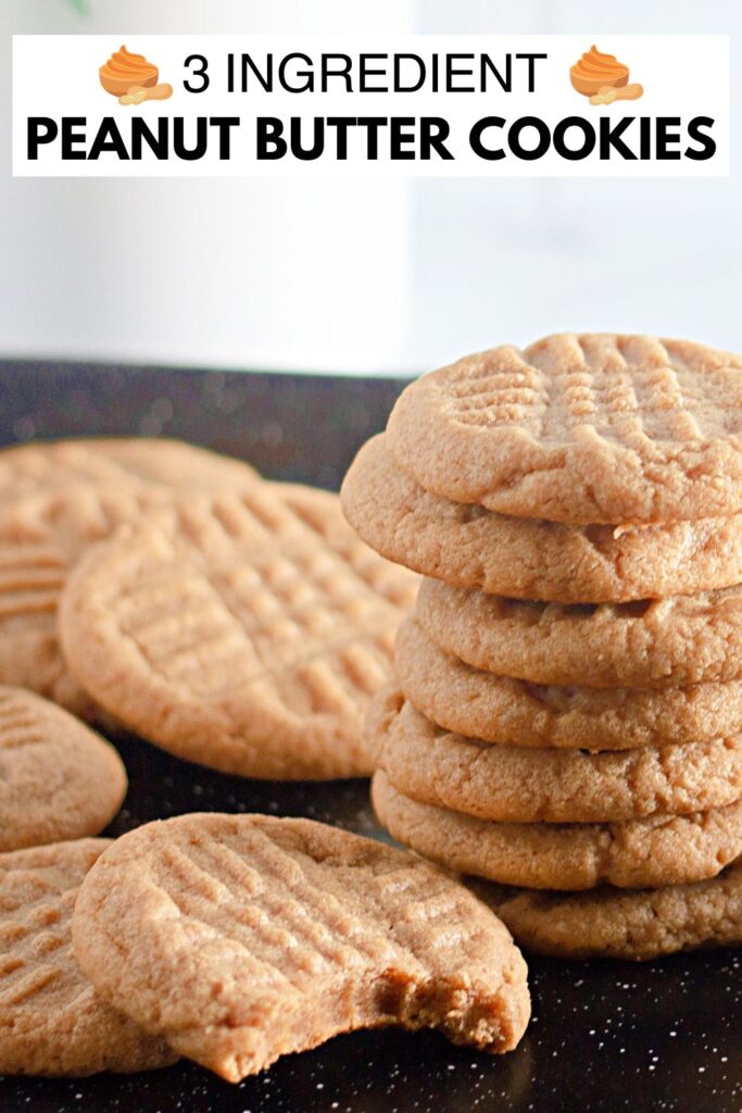 pb cookie on a cookie tray and one cookie has a bite taken out of it