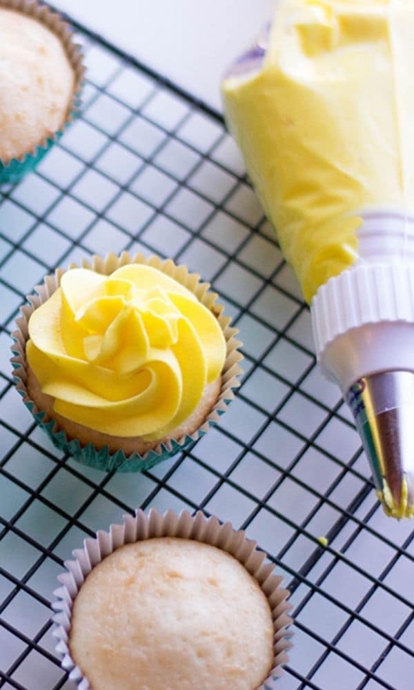 pineapple buttercream in piping container that is frosted