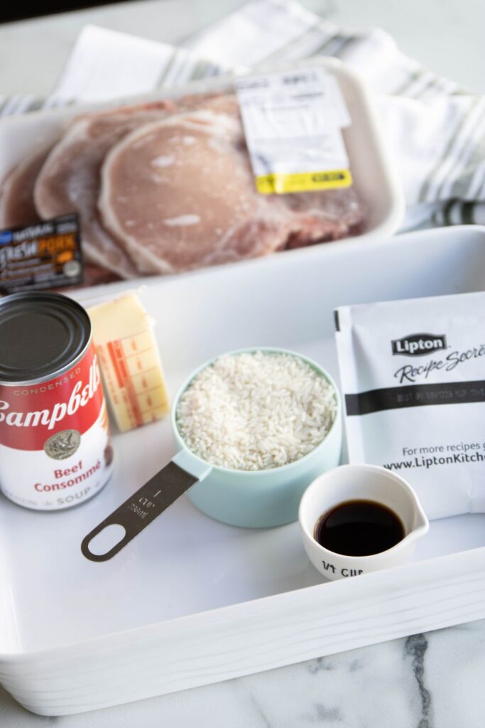 pork chops and ingredients for rice recipe in a pan
