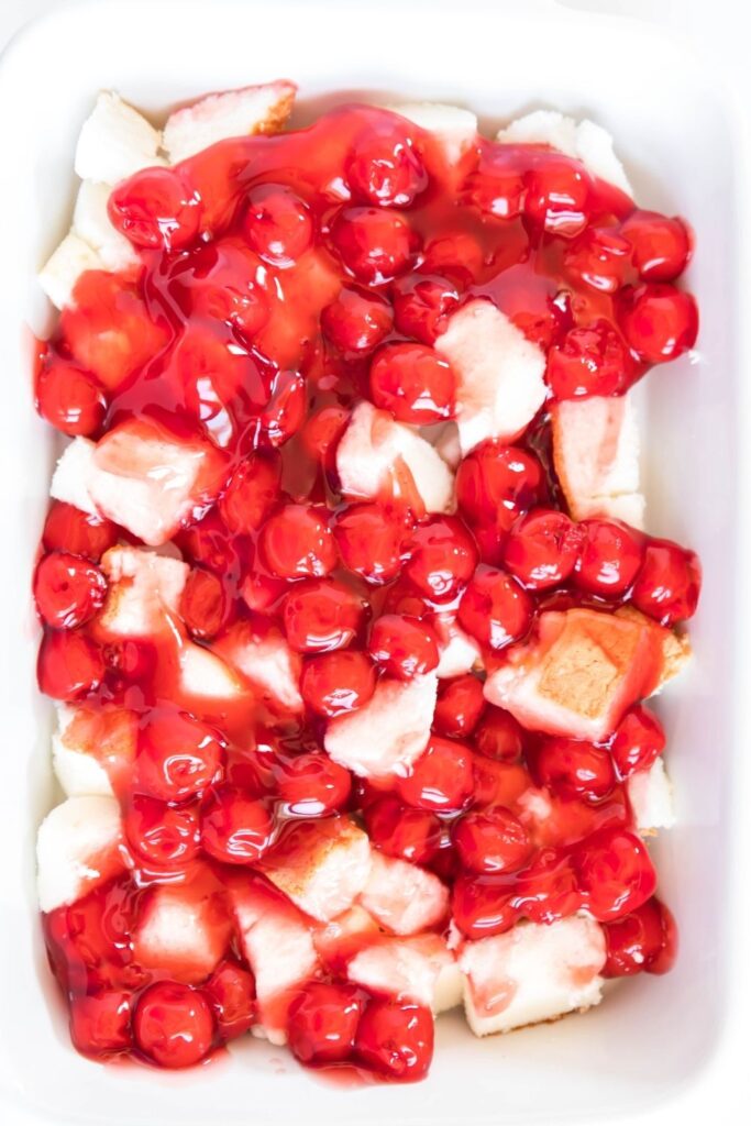 overhead shot of cherries and angel food in pan
