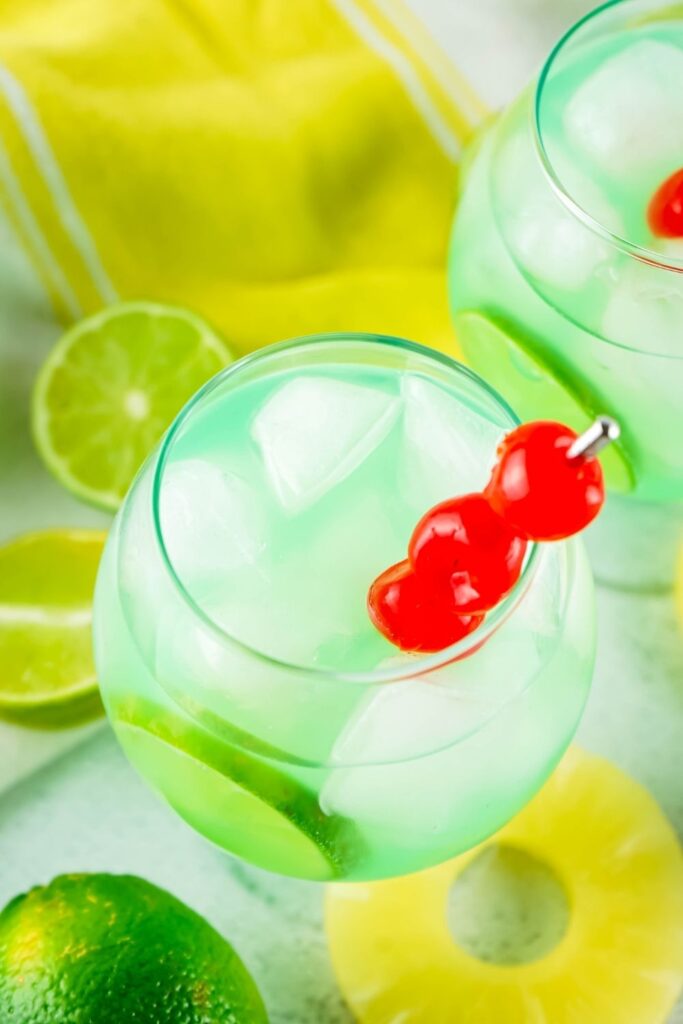 rum punch on table with lime and pineapple