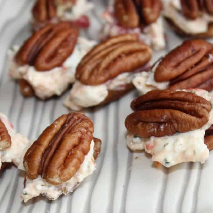 Savory and delicious pecan cheese ball bites are the perfect easy appetizer recipe to make. Stuffed pecan halves are stunning in looks and satisfying. #stuffedpecans #cheeseballbites #easyappetizers stuffed pecan halves