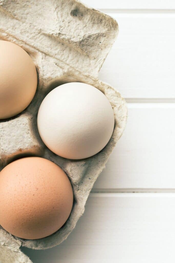 eggs in a carton on wooden counter