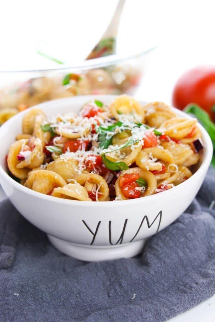 cold salad in a bowl that says yum on counter