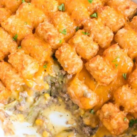 Tater Tot Casserole in a pan with some of it scooped out