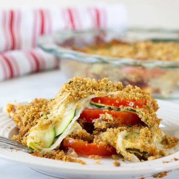 zucchini tomato casserole with melted cheese and herbs