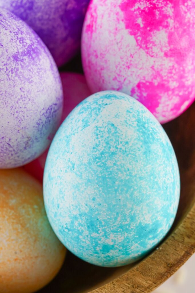 close up of Easter eggs colored in a bowl