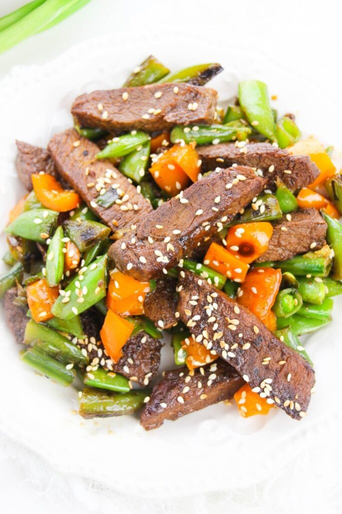 steak and vegetable stir fry on white plate