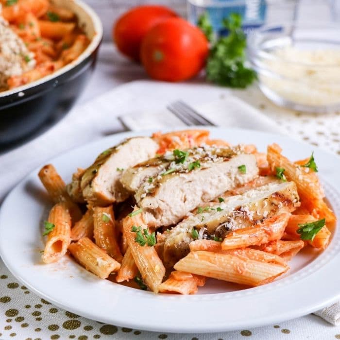vodka pasta plated up with pan behind it